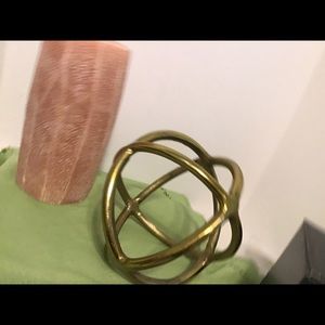 Metal round orb with tall candle. Nice decor.